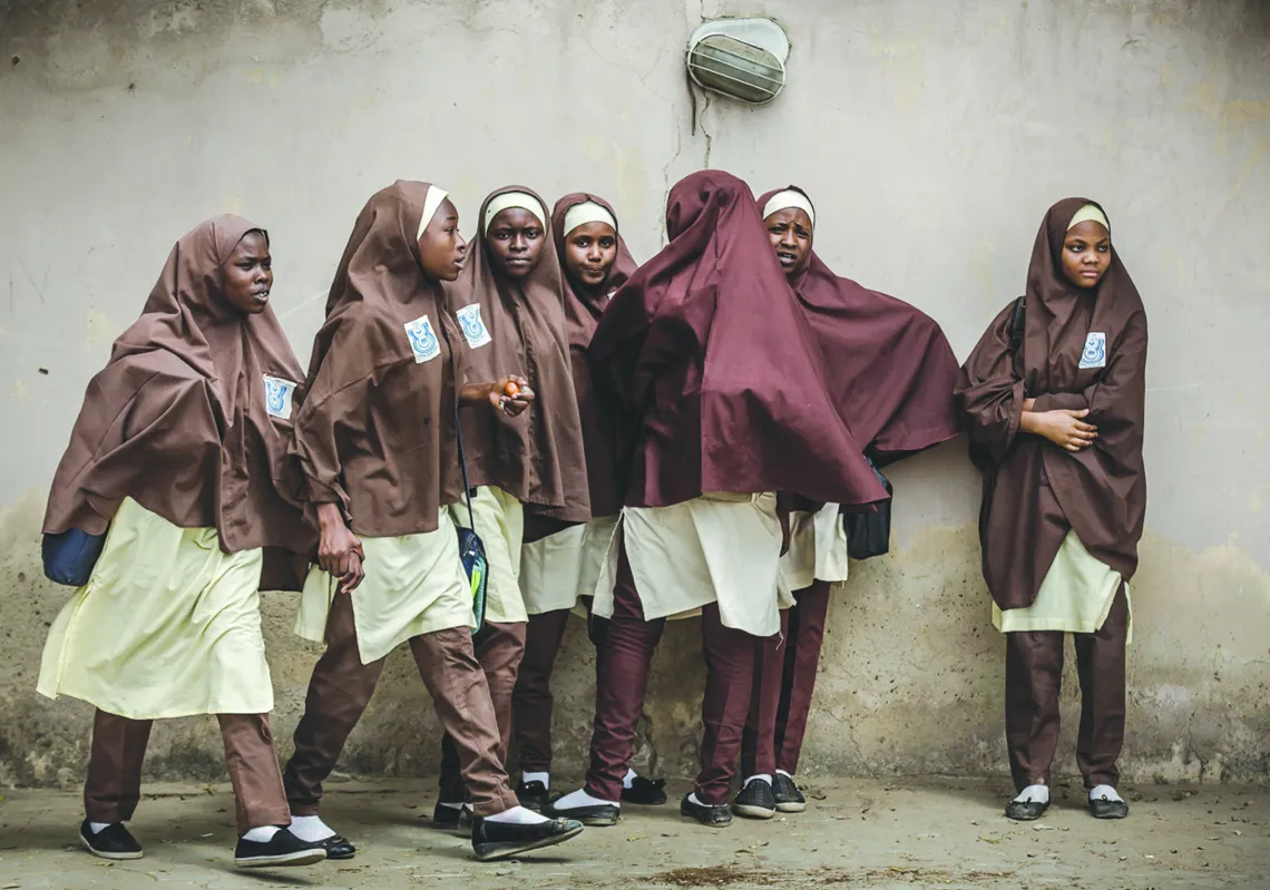 A group of girls leave their school during a rally by All Progressives Congress (APC) party supporters celebrating the re-election of the incumbent president and the leader of APC, in Kano on February 27, 2019. (Getty)