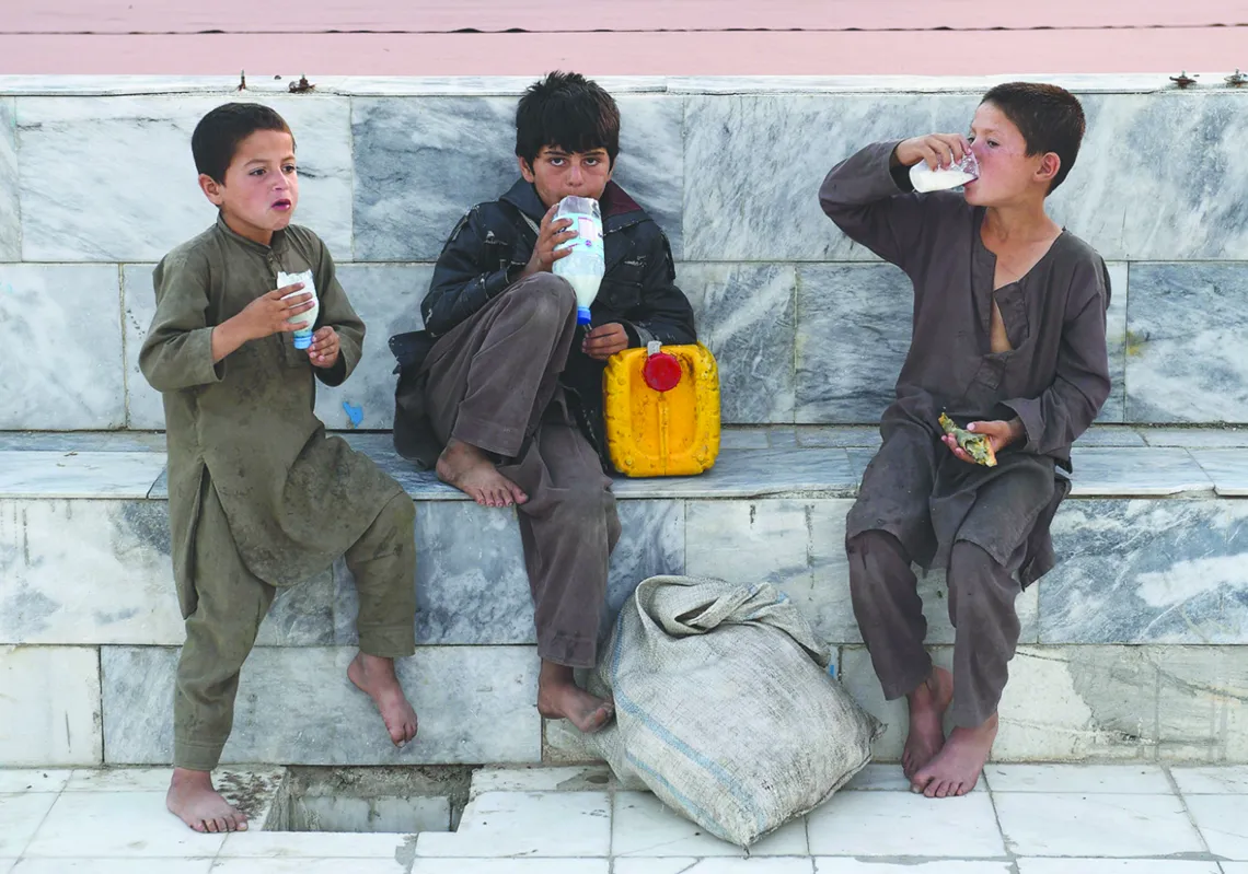 Afghan boys enjoy yogurt-based drinks in the courtyard of the Hazrat-e Ali shrine, or 'Blue Mosque', during the holy month of Ramadan in Mazar-i-Sharif. (Getty)
