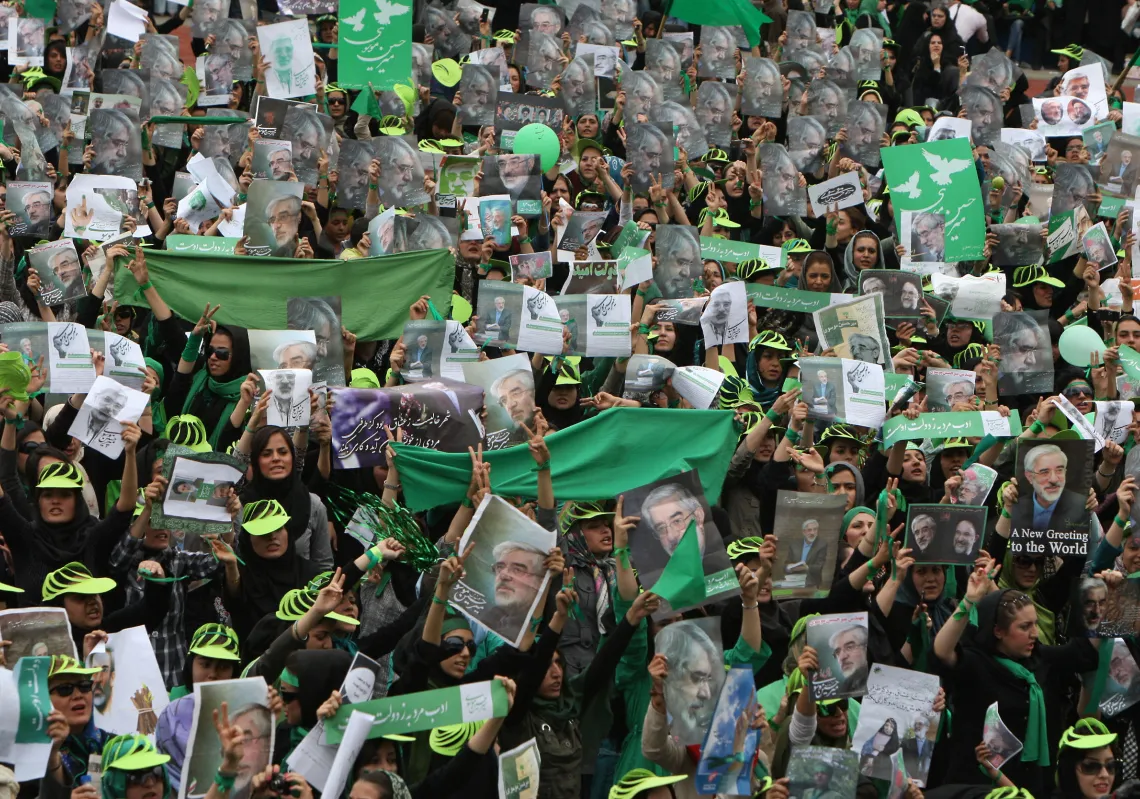 Supporters of Iranian presidential candidate Mir Hossein Mousavi wave green flags -- his campaign colour -- as they attend a pro-reform rally at Haydarniya Stadium in Tehran on June 9, 2009. (Getty)