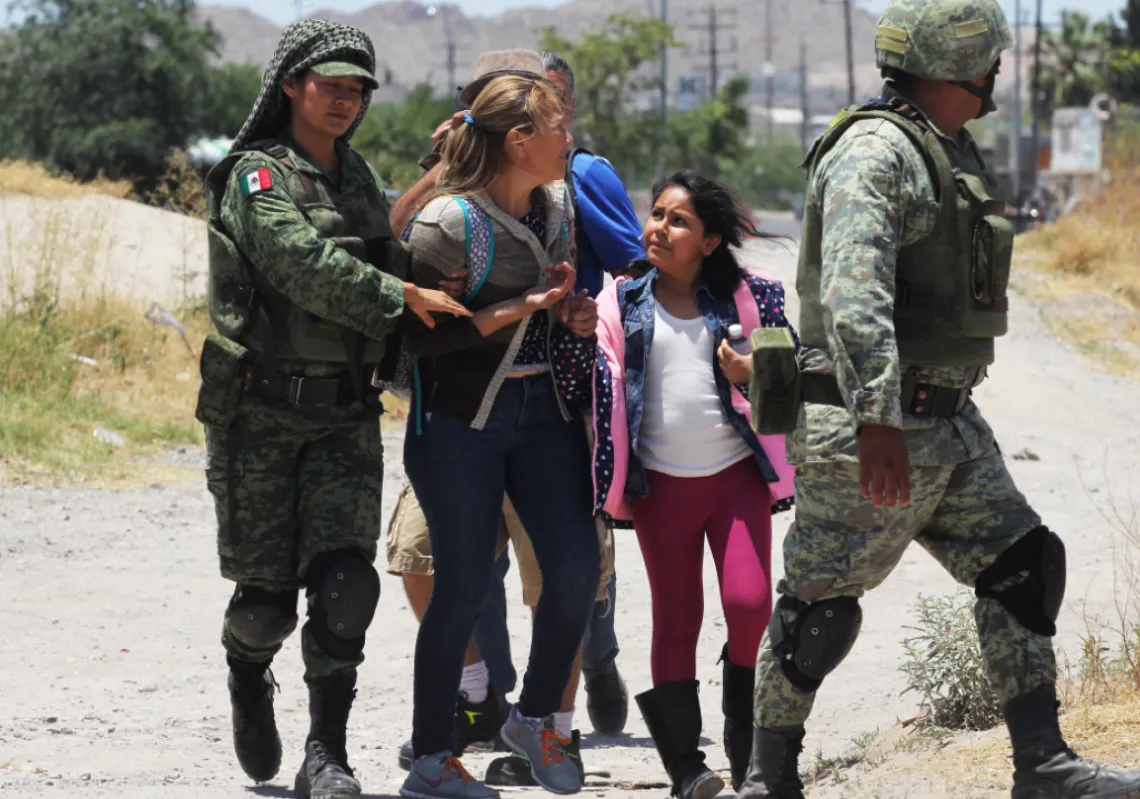 Members of Mexican National Guard detain Central American migrants trying to cross the Rio Bravo, in Ciudad Juarez, State of Chihuahua, on June 21, 2019. (Getty)