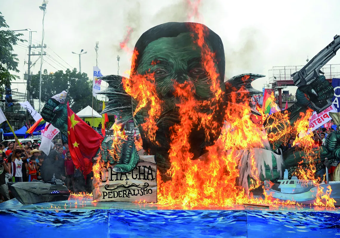  Activists burn an effigy of Philippine President Rodrigo Duterte depicted as a sea monster, during a protest near congress to coincide with Duterte's state of the nation address in Manila on July 22, 2019. (Getty)