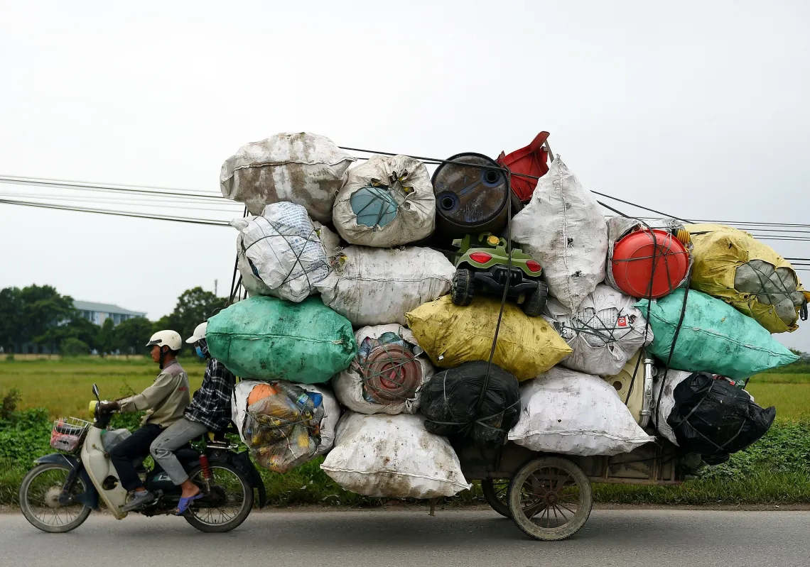 Waste collectors transport plastic scrap for recycling in the suburbs of Hanoi on October 15, 2019. (Getty)