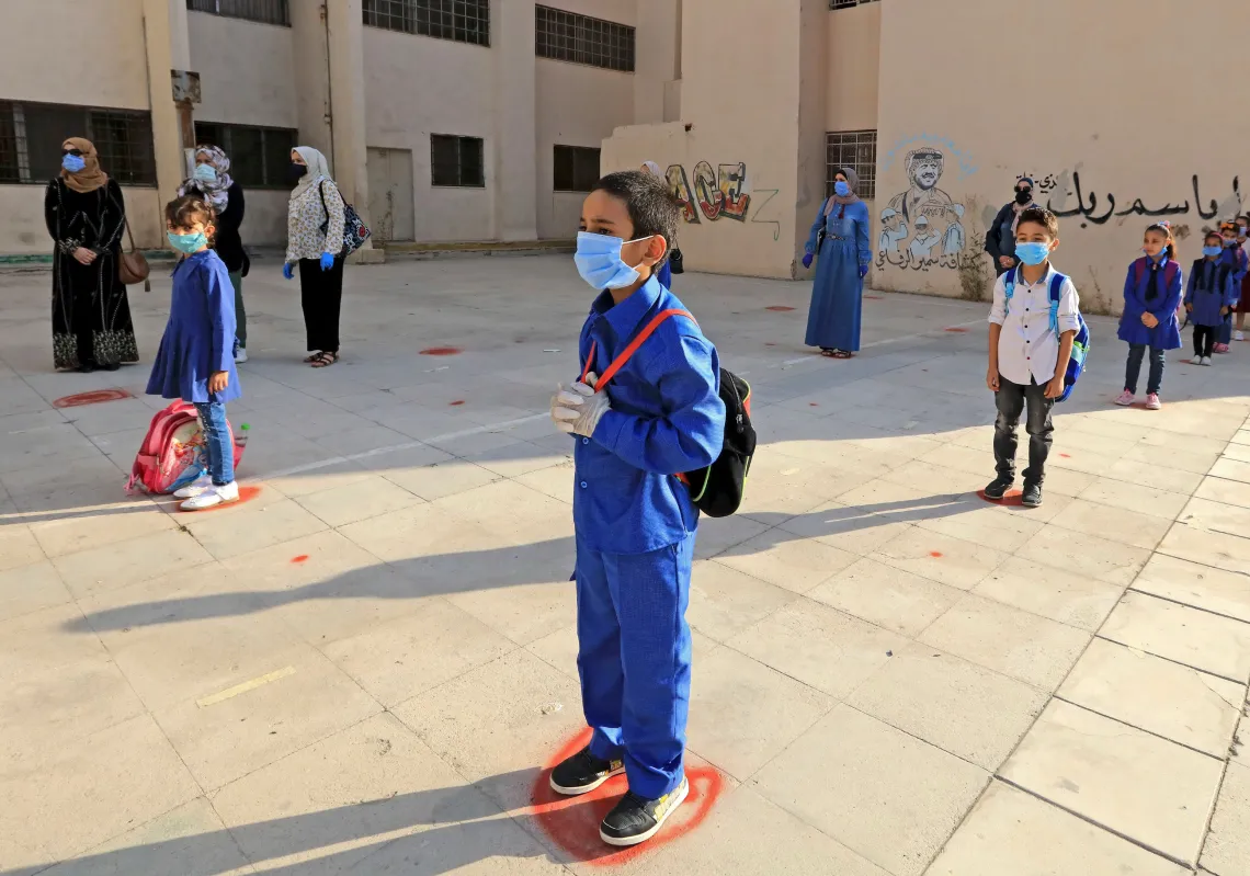  Students, wearing protective masks, wait in line on the first day of school in the Jordanian capital Amman amid the ongoing COVID-19 pandemic, on September 1, 2020.. (Getty)