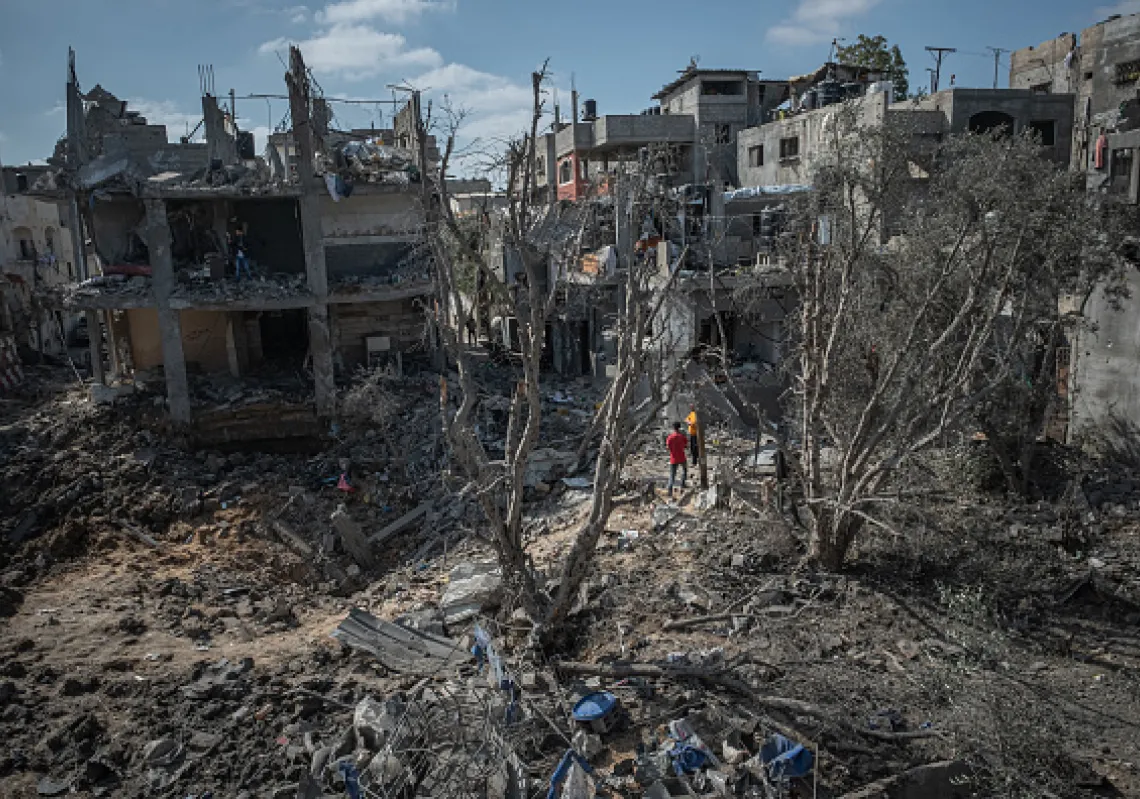 People inspect the damage done to Beit Hanoun after a night of Israeli raids on May 14, 2021 in Gaza City, Gaza. (Getty)