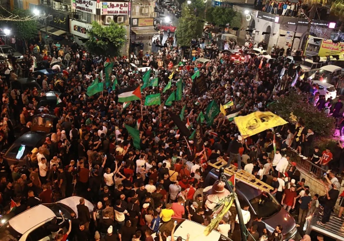 Palestinians gather for a celebration after "mutual and simultaneous" cease-fire deal between Israel and Hamas reached with Egypt mediation took effect at 2 a.m, in Ramallah, West Bank on May 21, 2021. (Getty)