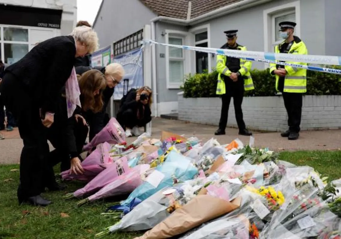 Well-wishers lay floral tributes at the scene of the fatal stabbing of Conservative British lawmaker David Amess, at Belfairs Methodist Church in Leigh-on-Sea, a district of Southend-on-Sea, in southeast England on October 16, 2021. - The fatal stabbing of British lawmaker David Amess was a terrorist incident, police said Saturday, as MPs pressed for tougher security in the wake of the second killing of a UK politician while meeting constituents in just over five years. (Photo by Tolga Akmen / AFP)