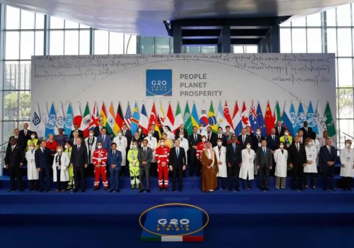 Italian Prime Minister Mario Draghi (C-front) stands with the Italian medical team and world leaders as they gather for the official family photograph on day one of the G20 Summit at the convention center of La Nuvola, in the EUR district of Rome on October 30, 2021.(Photo by Ludovic MARIN / POOL / AFP)