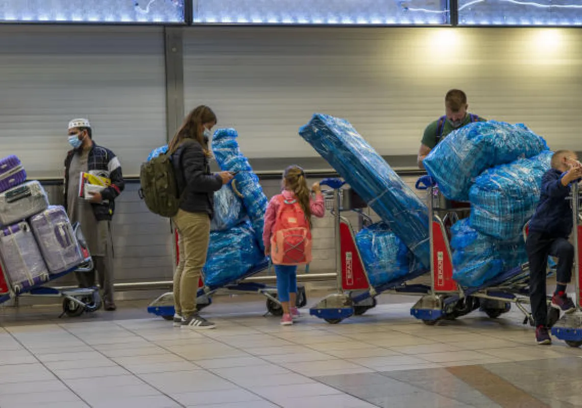 People line up to get on an overseas flight at OR Tambo International Airport in Johannesburg, South Africa, Nov. 26, 2021. (AP Photo/Jerome Delay)