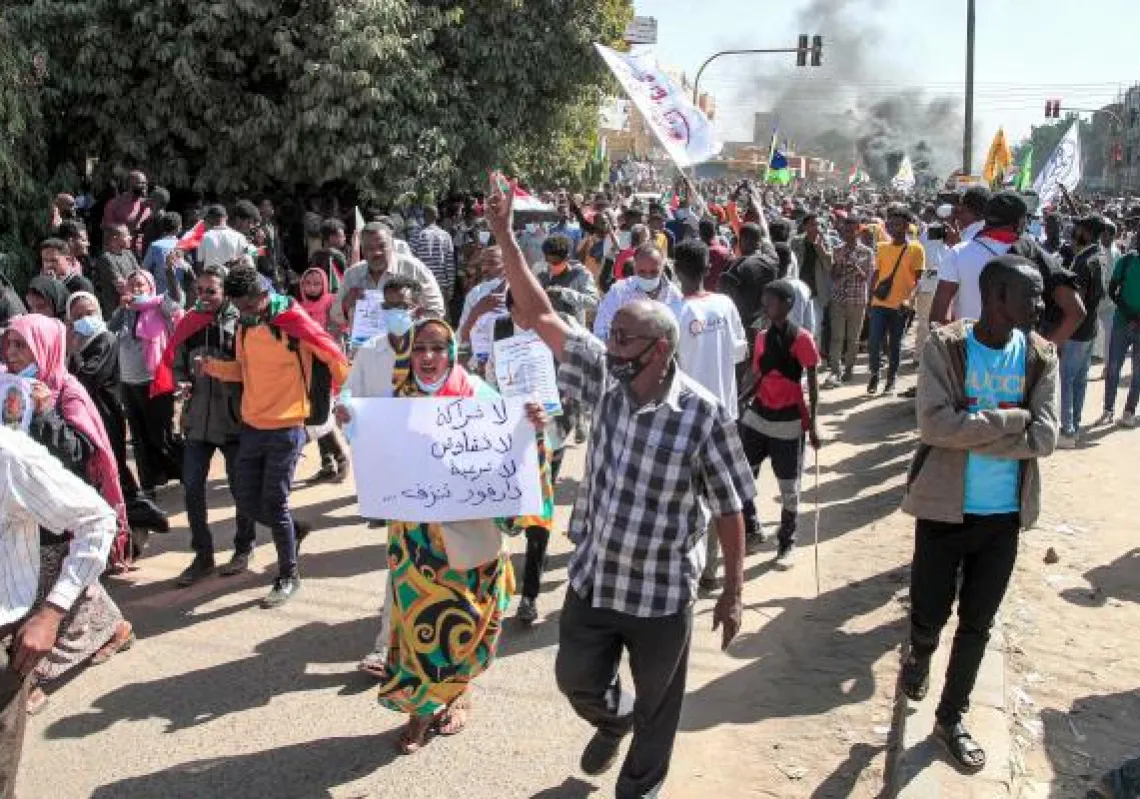 Protesters march during a mass demonstration demanding civilian rule, in the Sahafa neighbourhood in the south of Sudan's capital Khartoum on December 25, 2021. (Photo by AFP)
