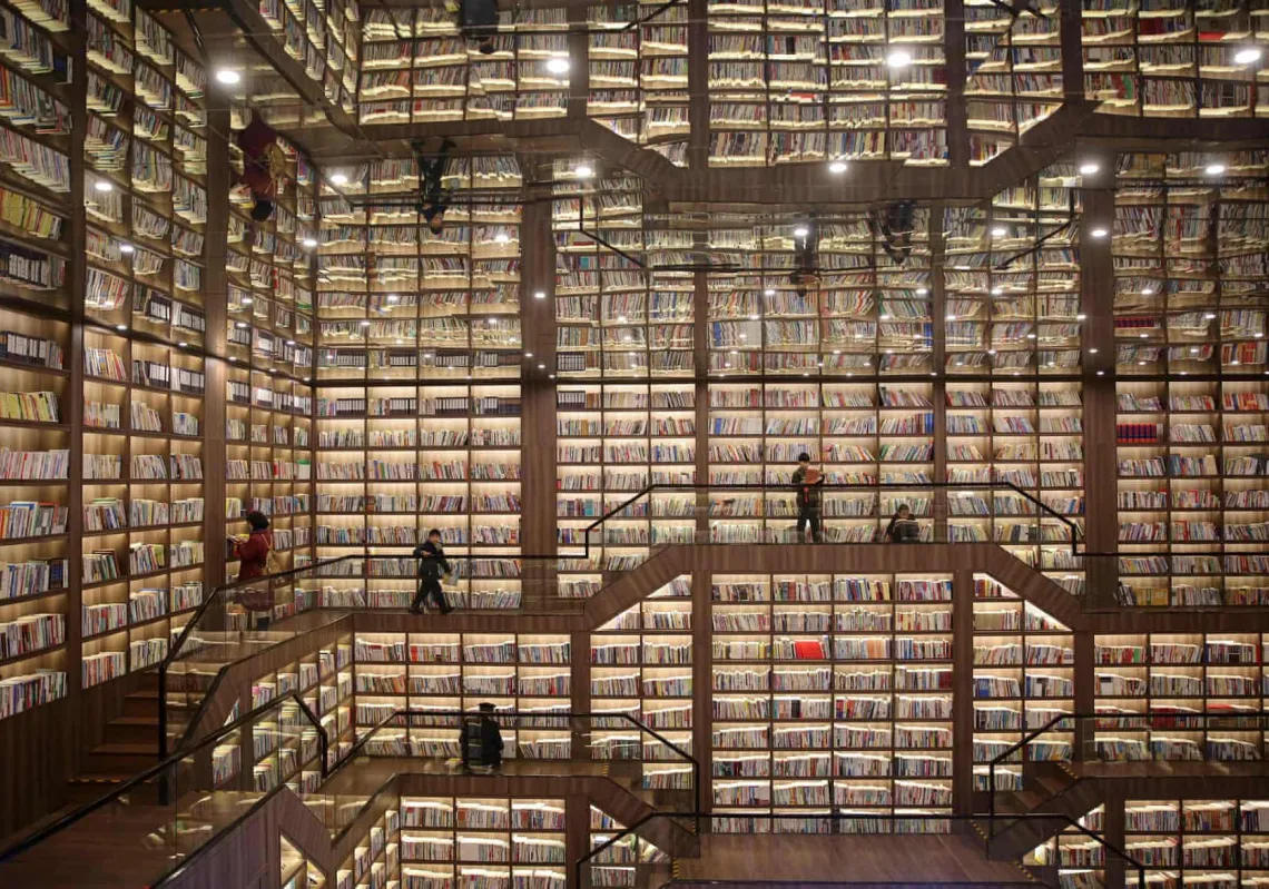 Readers peruse the vast collection at Shaoyang library in Hunan, which has a mirrored ceiling. (Getty)