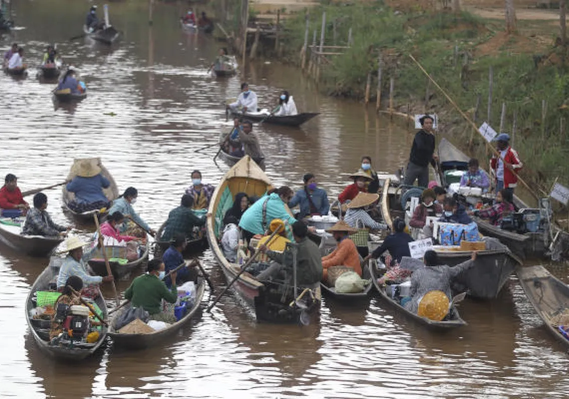 Vendors on boats sell foods to visitors at a local floating market in famous Innlay Lake, southern Shan State, Myanmar Saturday, Jan. 15, 2022. (AP Photo)