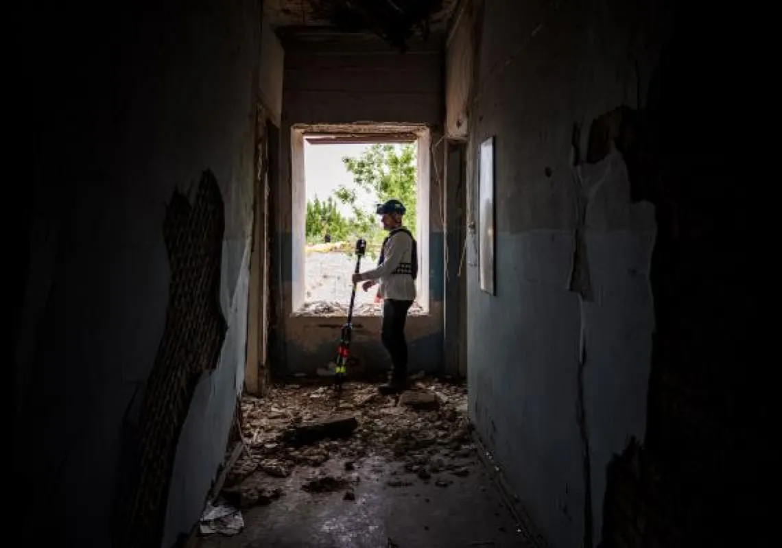 French engineer and specialist in 3D data acquisition Emmanuel Durand uses his laser-scanner on May 26, 2022, to map the architecture of the Karkhiv fire station built in 1887.  (Photo by Dimitar DILKOFF / AFP)