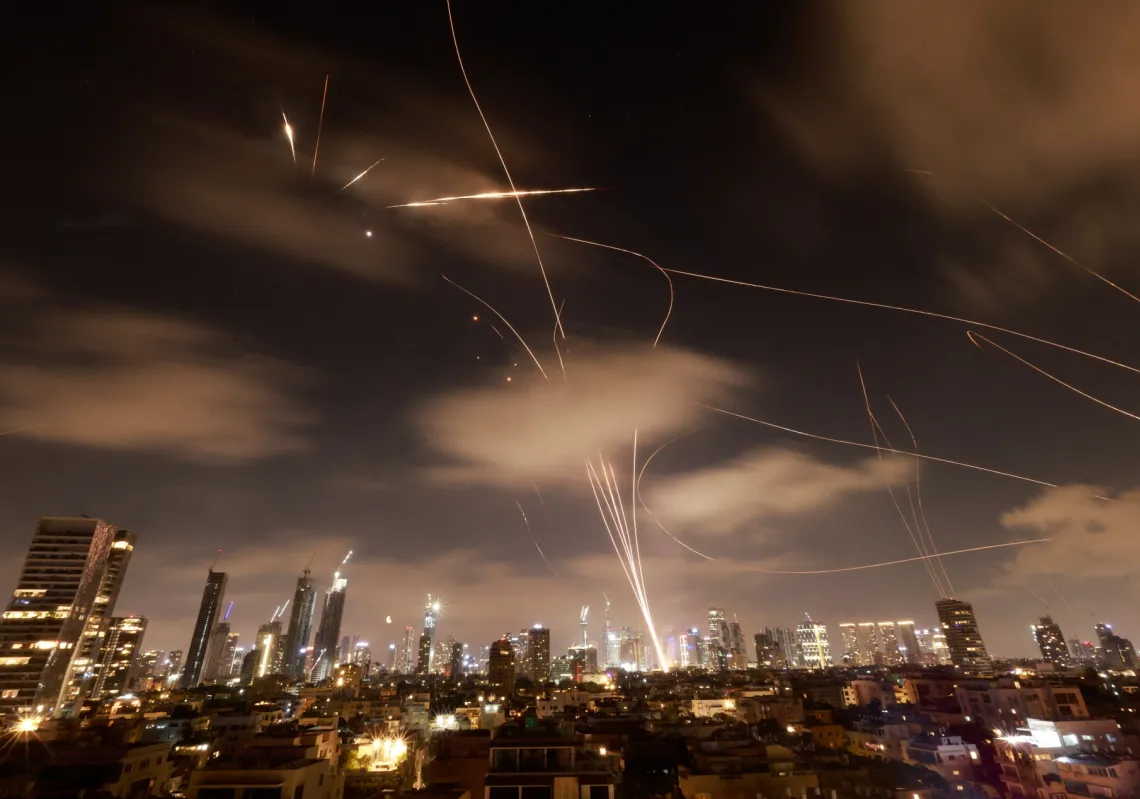 Israeli air defence systems intercept Iranian missiles over Tel Aviv on June 18, 2025.
