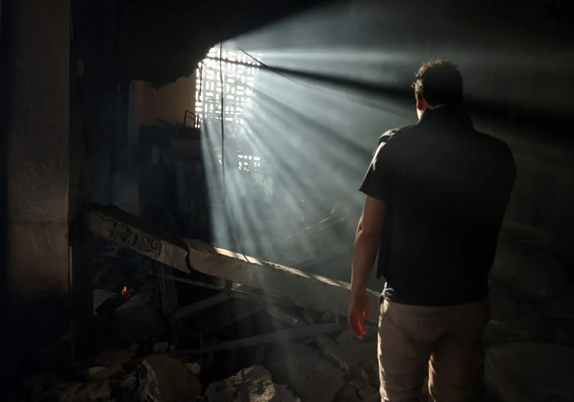 A man checks the destruction inside the heavily damaged Syrian army and defence ministry headquarters complex in Damascus, following Israeli strikes on July 16, 2025.
