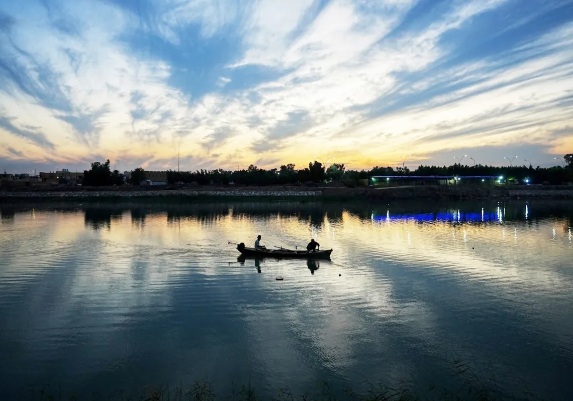 An Iraqi fisherman casts his net in the Euphrates River, which passes through the city of Nasiriyah the capital of the Iraqi Dhi Qar Governorate on January 2, 2024. 