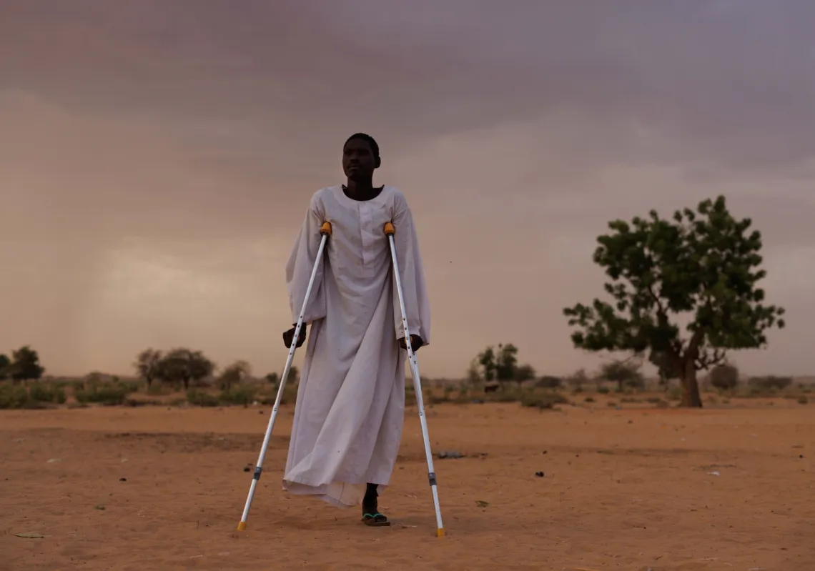 Ishag Abdullah Khatir, 30, from Geneina in West Sudan, whose leg was amputated after RSF soldiers shot him, poses for a portrait on April 20, 2024, in Adre, Chad. 