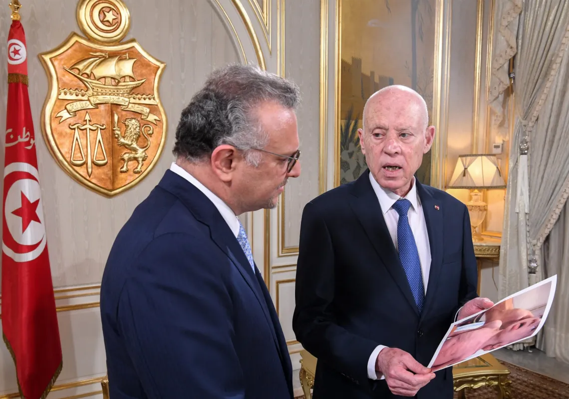 Tunisia's President Kais Saied (R) shows Massad Boulos, senior adviser to the US president for Africa, pictures of starving children in Gaza during their meeting at the presidential palace in Carthage on July 22, 2025.