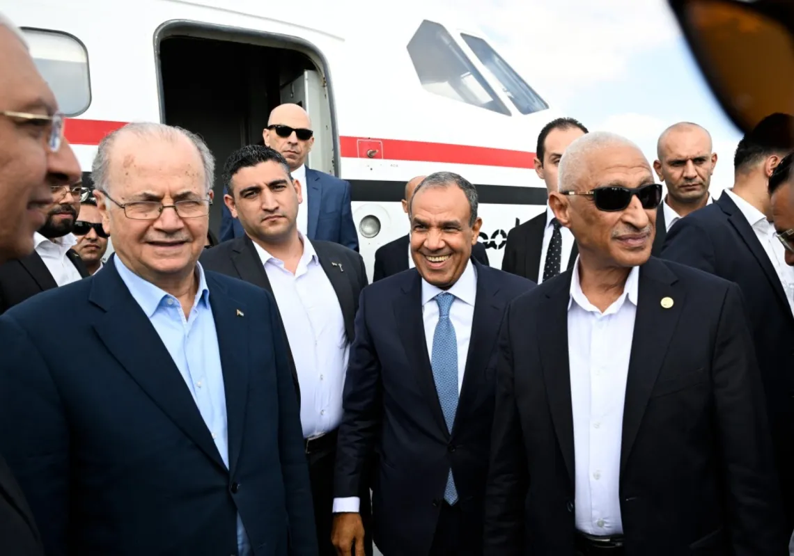 Palestinian Prime Minister Mohammad Mustafa (L), accompanied by Egypt's Foreign Minister Badr Abdelatty (C), arrives at an airport in El-Arish on August 18, 2025, to visit Palestinians wounded in Israel's war on Gaza.