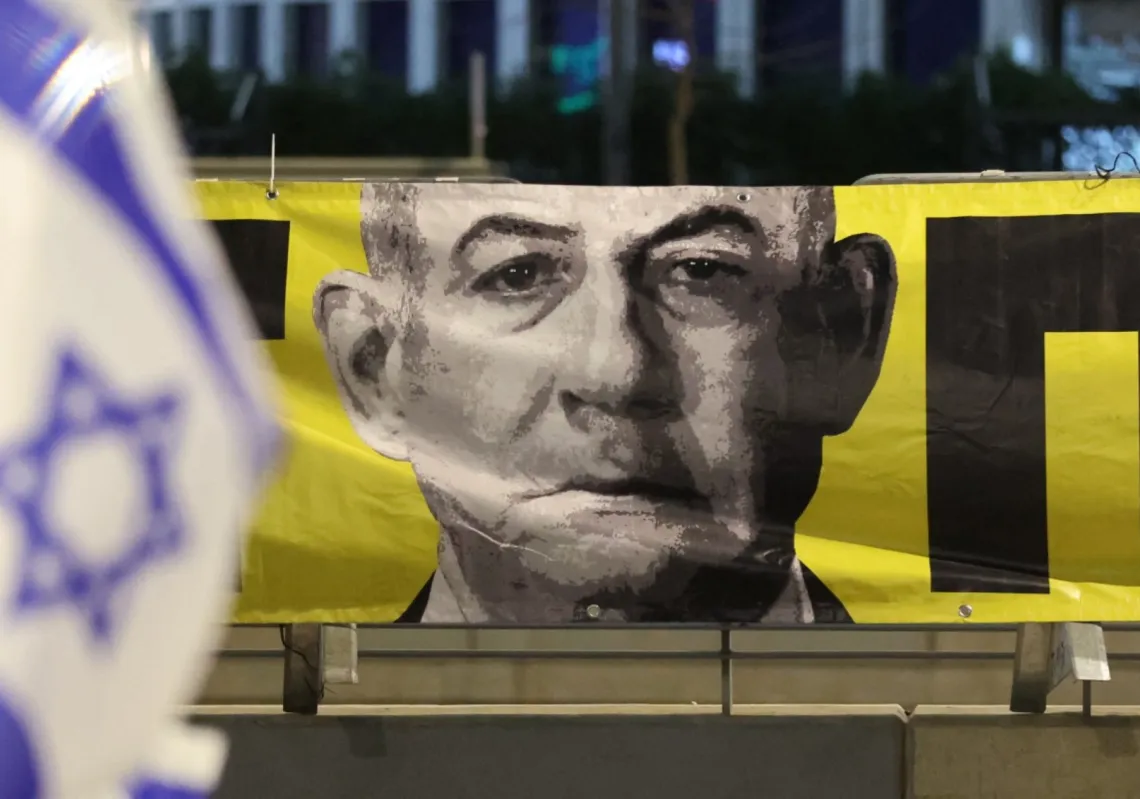 A portrait of Israel's Prime Minister Benjamin Netanyahu hangs during an anti-government protest calling for action to secure the release of Israeli hostages in Tel Aviv on March 29, 2025.