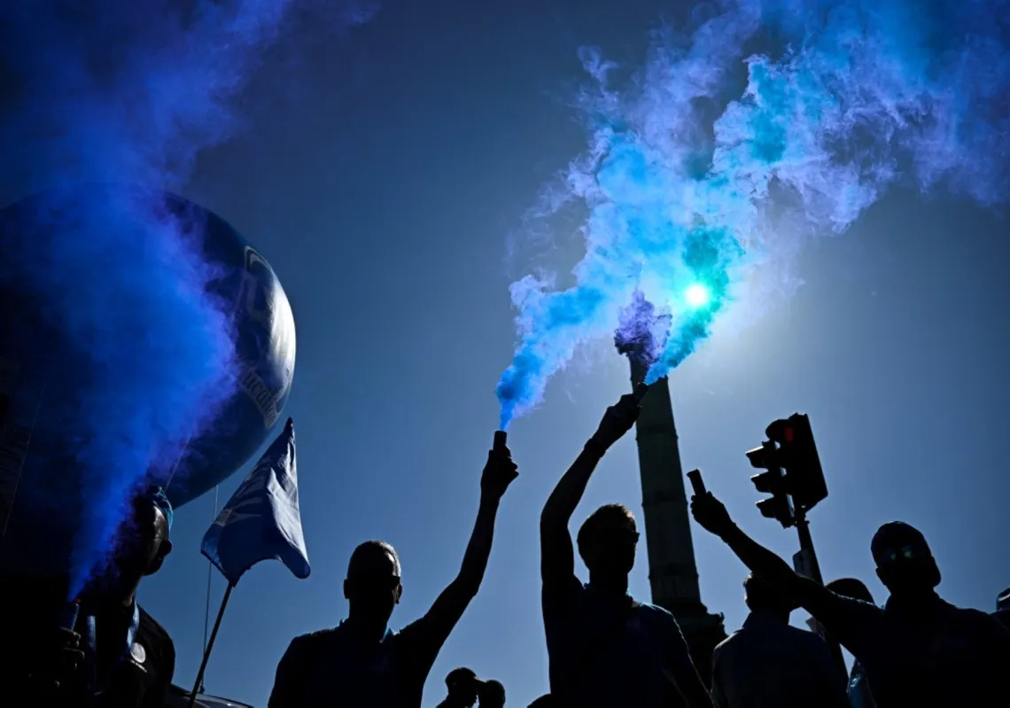 Protesters stand in front of the July Column at Place de la Bastille in central Paris, on September 18, 2025, during a demonstration part of a day of nationwide strikes and protests called by unions over France's national budget. 