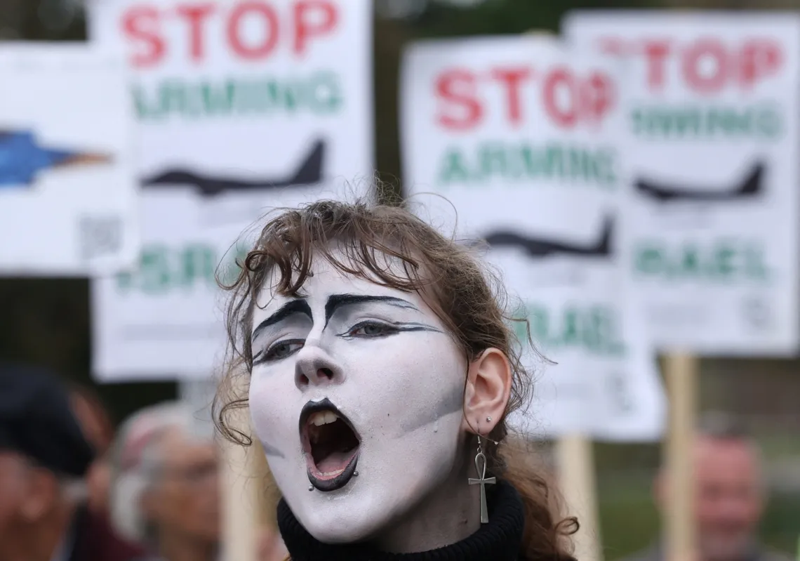 A protester highlights British companies’ involvement in manufacturing F-35 fighter jets used in Gaza, demanding an arms embargo on Israel, outside the offices of Lockheed Martin, in Havant, Britain, October 8, 2025. 