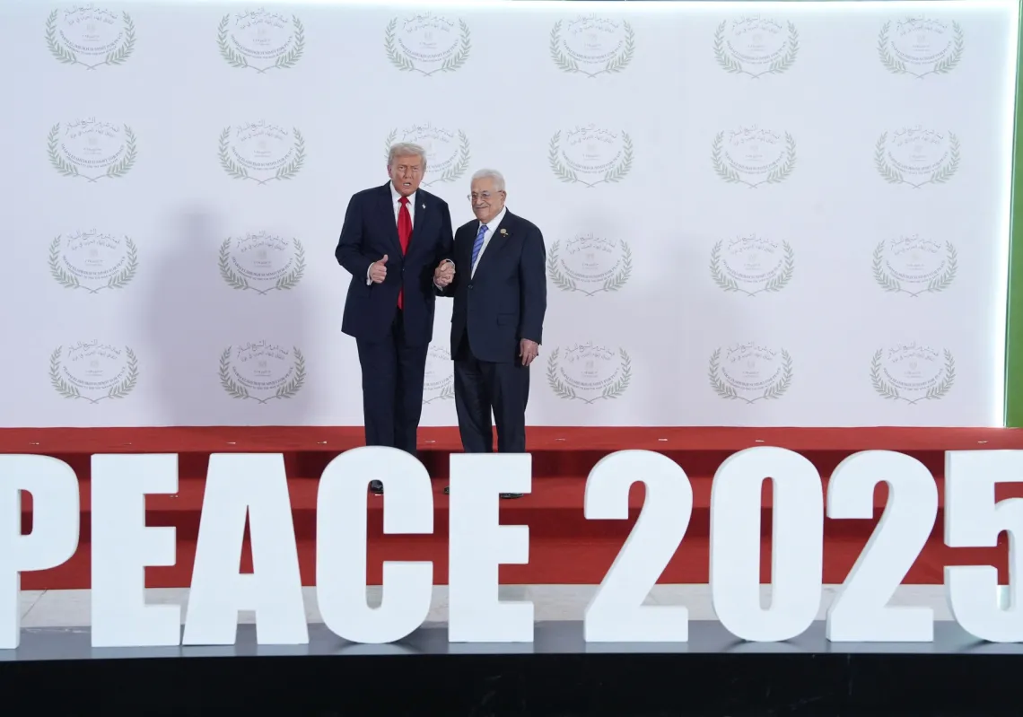 US President Donald Trump greets Palestinian President Mahmud Abbas during a summit on Gaza in Sharm el-Sheikh on October 13, 2025.