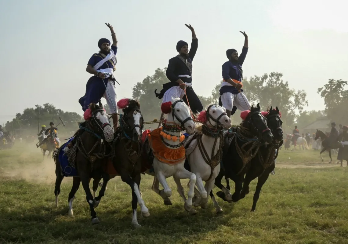 Nihang Sikh warriors ride on horses as they display their skills on the occasion of Fateh Divas in Amritsar on 22 October 2025. 