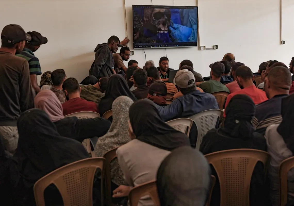 Details of the remains of Palestinians released by Israel are shown on a screen in order to help family members to identify their relatives, at the Nasser hospital in Khan Yunis in the southern Gaza Strip on 18 October 2025.