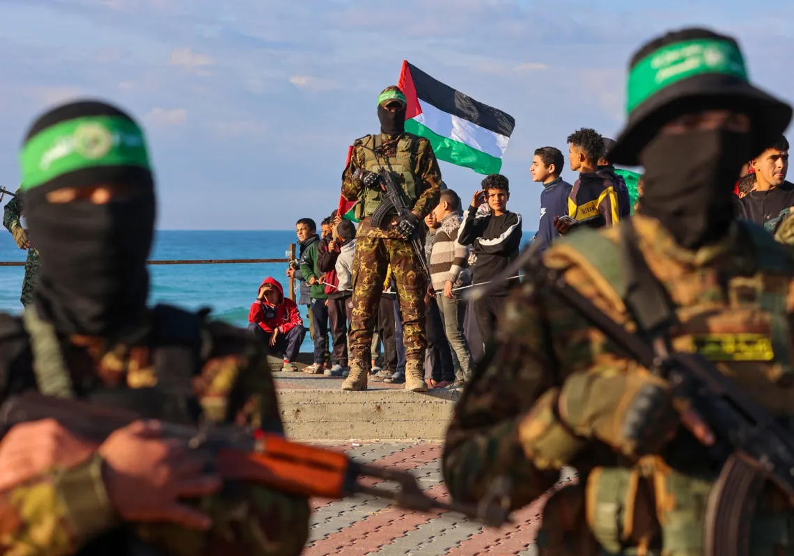 Hamas fighters secure an area before handing over an Israeli-American hostage to a Red Cross team in Gaza City on February 1, 2025, as part of the fourth hostage-prisoner exchange. 