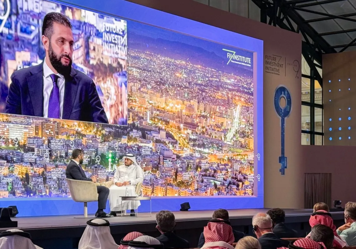 Syria's interim President Ahmed al-Sharaa (L) speaks during the Future Investment Initiative (FII) conference in Riyadh on 29 October 2025.
