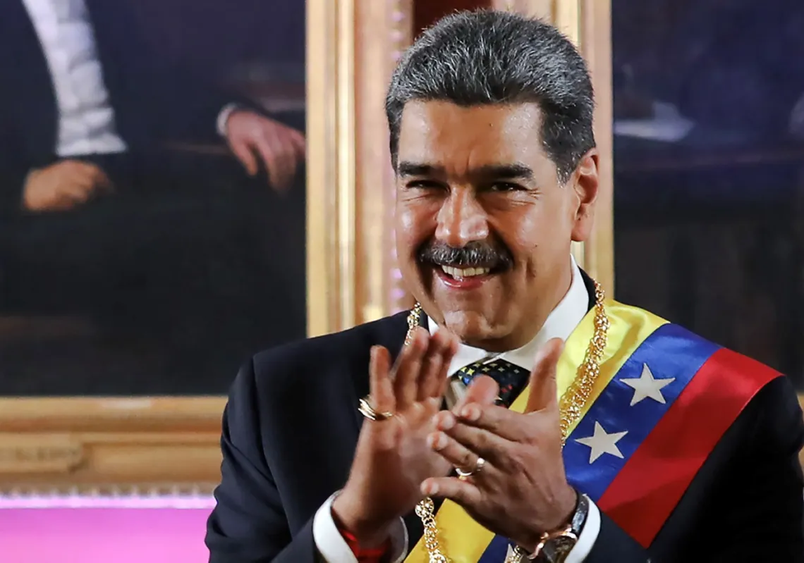 Venezuelan President Nicolas Maduro applauding after taking the oath during the presidential inauguration at the Capitolio -home of the National Assembly- in Caracas on 10 January 2025. 