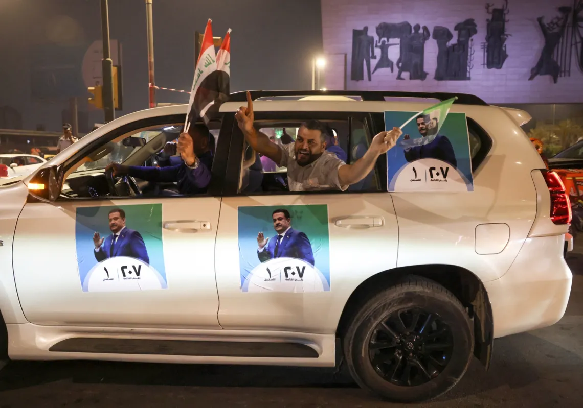 Supporters of the Reconstruction and Development Coalition celebrate after preliminary election results were announced in Baghdad, Iraq, on 12 November 2025. 