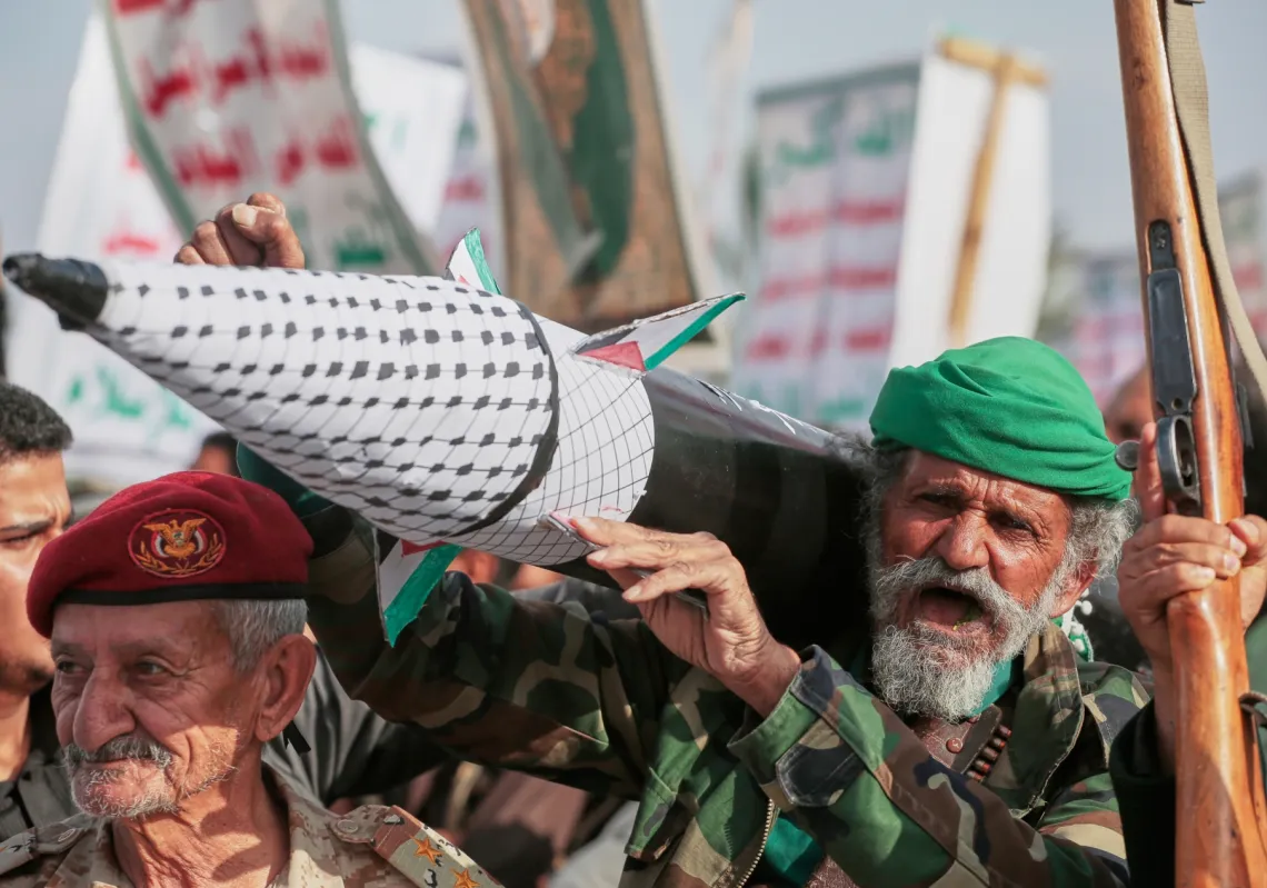 A Houthi supporter chants slogans as he carries a rocket replica during an anti-US and anti-Israel rally in Sanaa, Yemen, on Friday, September 26, 2025. 