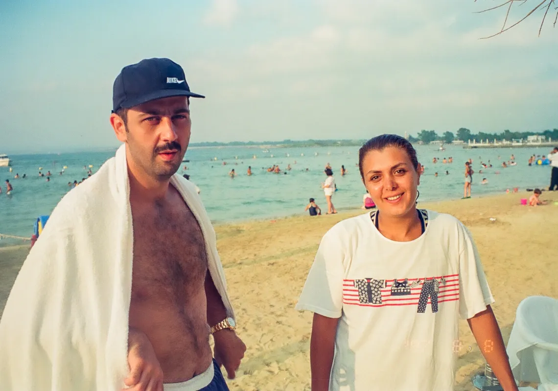 Maher al-Assad with his wife Manal al-Jadaan on the beach.