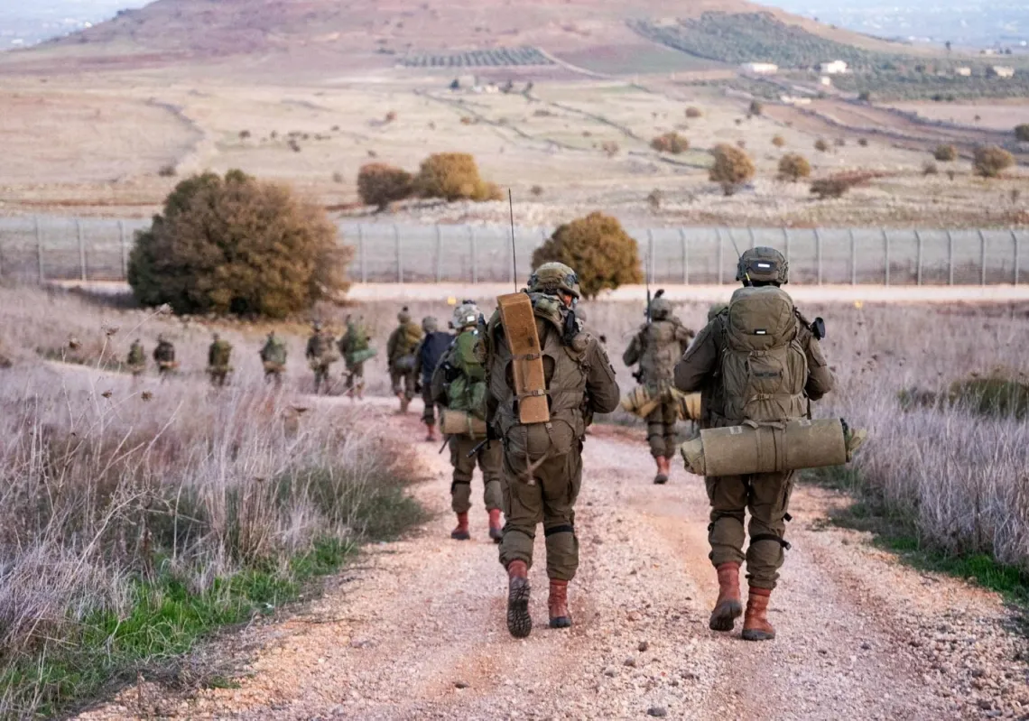 Israeli Paratroopers' Brigade members operate in a location given as the
Syrian border, in this handout picture
released on 13 December 2024.