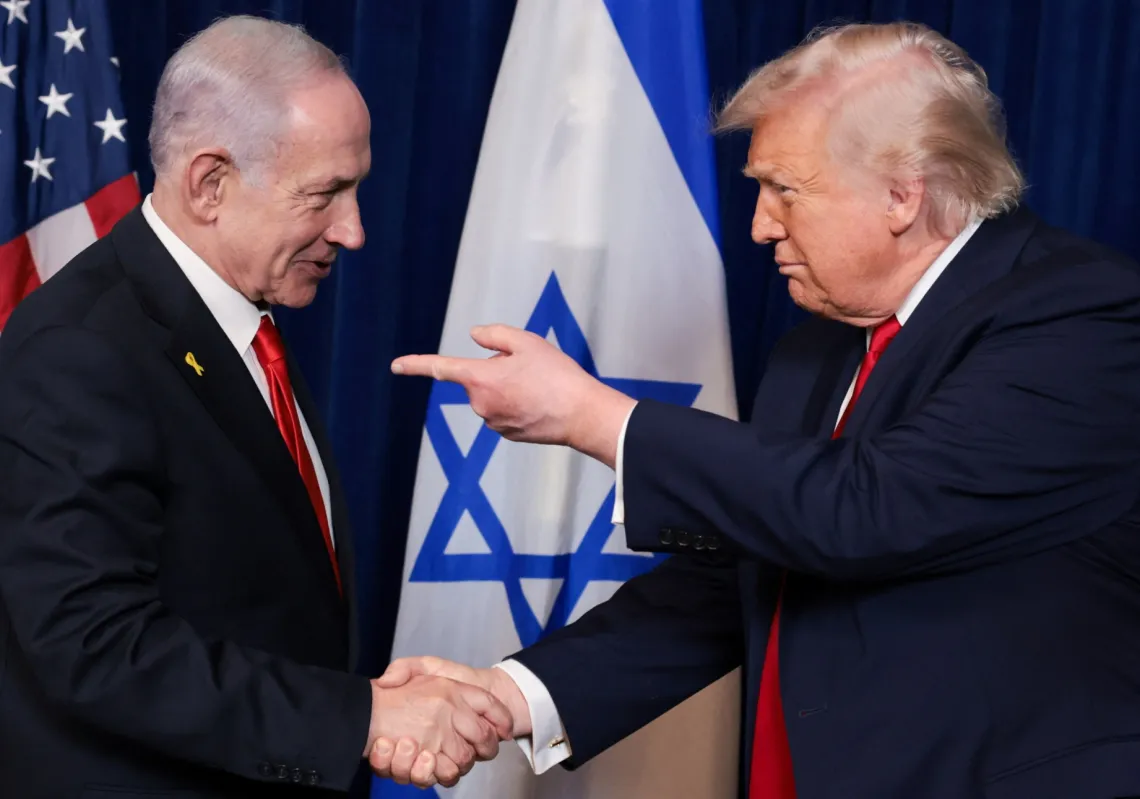 US President Donald Trump points his finger towards Israeli Prime Minister Benjamin Netanyahu as they shake hands during a press conference after meeting at Trump’s Mar-a-Lago club in Palm Beach, Florida, on 29 December 2025.