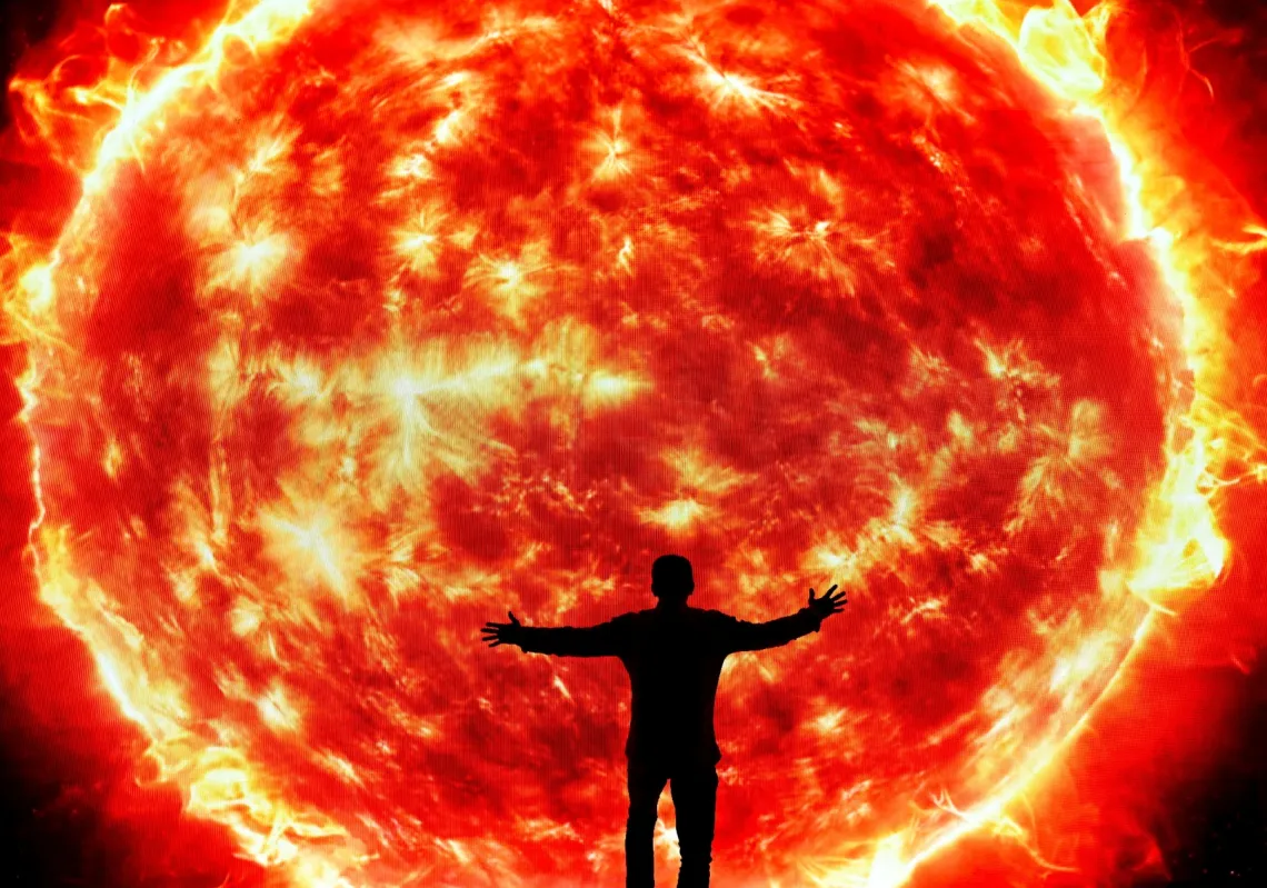 A man extends his arms in front of a screen showing a picture of the sun in the La Carlota convention center during the inauguration of a space-themed children's exhibition on the solar system, in Caracas, Venezuela December 5, 2025