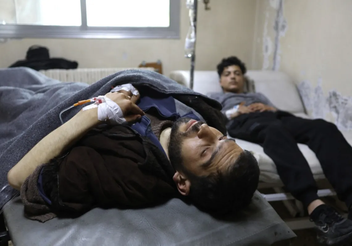 Men recover at the Karm al-Louz Hospital following an explosion at the Imam Ali ibn Abi Talib Mosque, in Homs, on 26 December 2025.