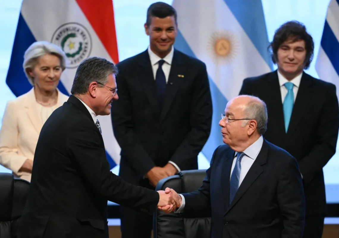 European Commissioner for Trade and Economic Security Maros Sefcovic (L) and Brazil's Foreign Minister Mauro Vieira shake hands after signing a EU-Mercosur trade agreement in Asuncion, Paraguay, on 17 January 2026.