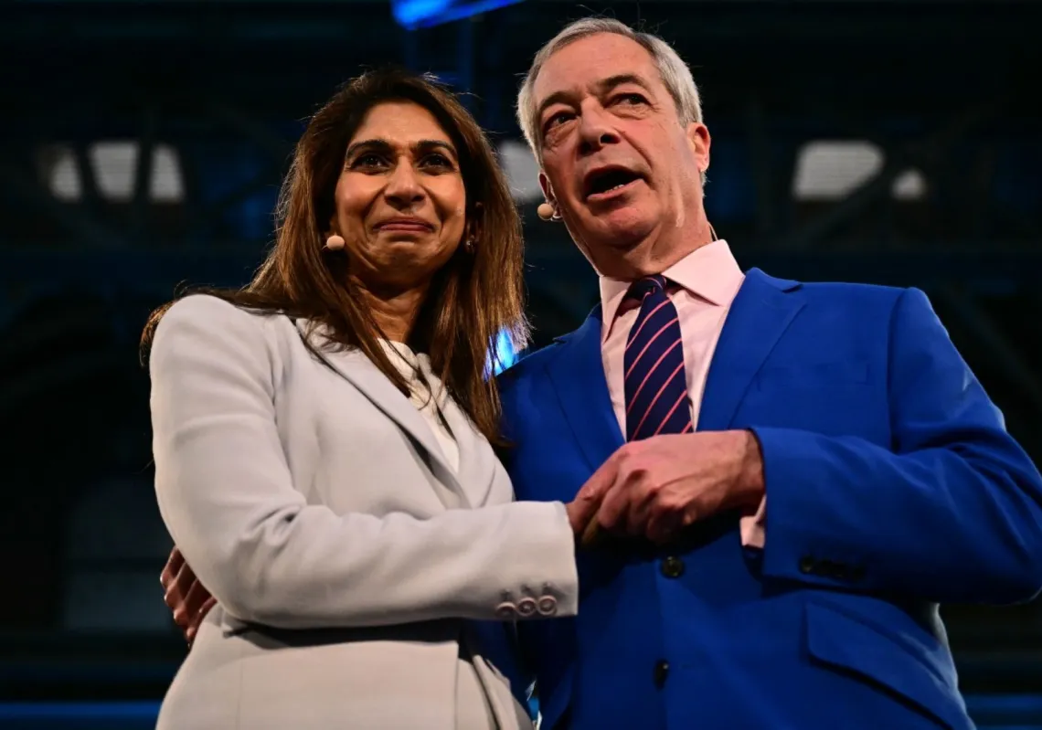 Reform UK leader Nigel Farage stands  with former Conservative Party MP and former Home Secretary Suella Braverman during a Reform UK press conference in London on 26 January 2026,  where she announced her defection to Reform.