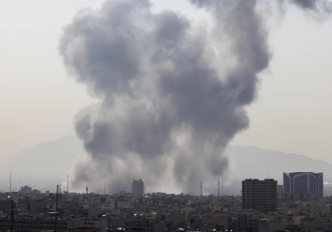 A plume of smoke rises following a reported explosion in Tehran on 28 February 2026 as US and Israeli attacks on the country commence.