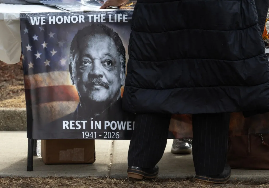 A vendor sells merchandise to people paying their respects to the late civil rights leader Rev. Jesse Jackson outside of the Rainbow PUSH Coalition national headquarters on 27 February 2026 in Chicago, Illinois.