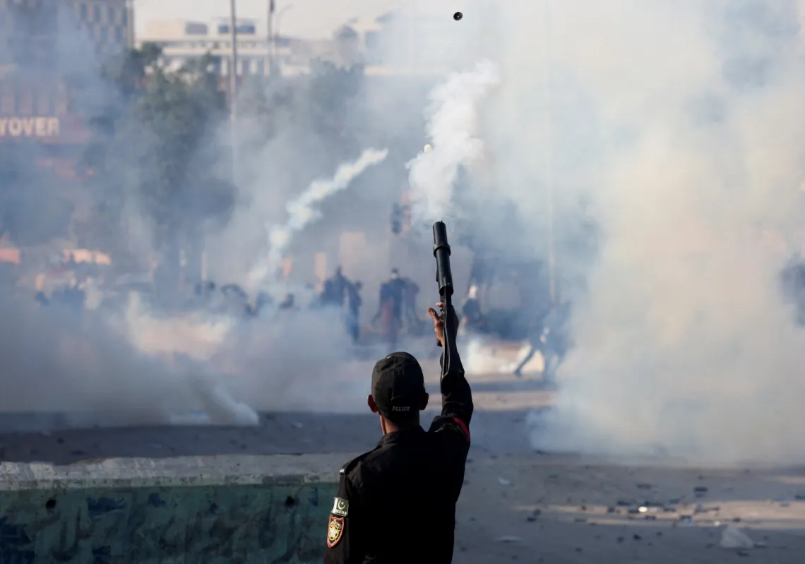 أطلق شرطي قنبلة غاز مسيل للدموع لتفريق احتجاج خارج مبنى البرلمان في كراتشي، باكستان، في 1 مارس 2026