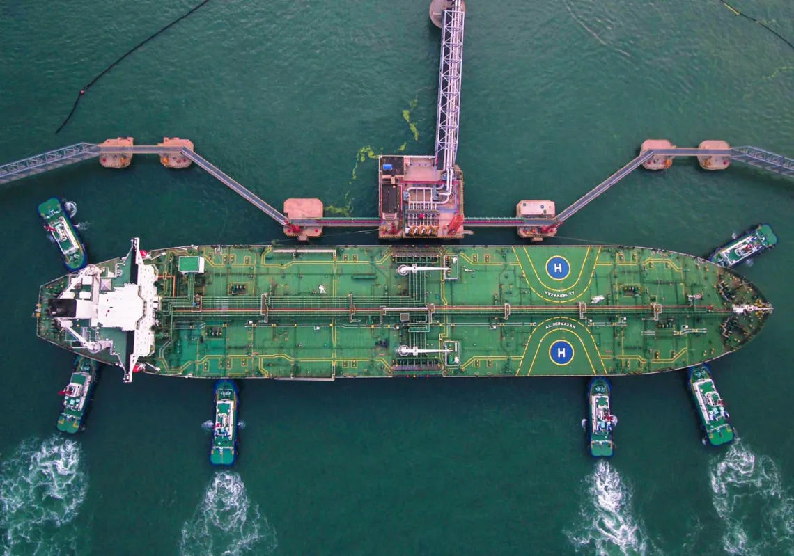 Tugboats help an oil tanker dock at Qingdao port in Shandong province, eastern China, on 4 August 2019.