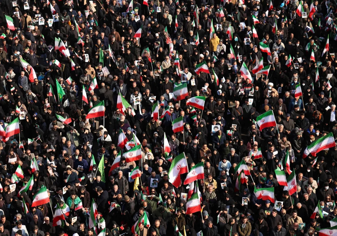Demonstrators wave Iranian national flags as they gather for a rally in support of the new Supreme Leader at Enghelab Square in central Tehran on 9 March 2026.