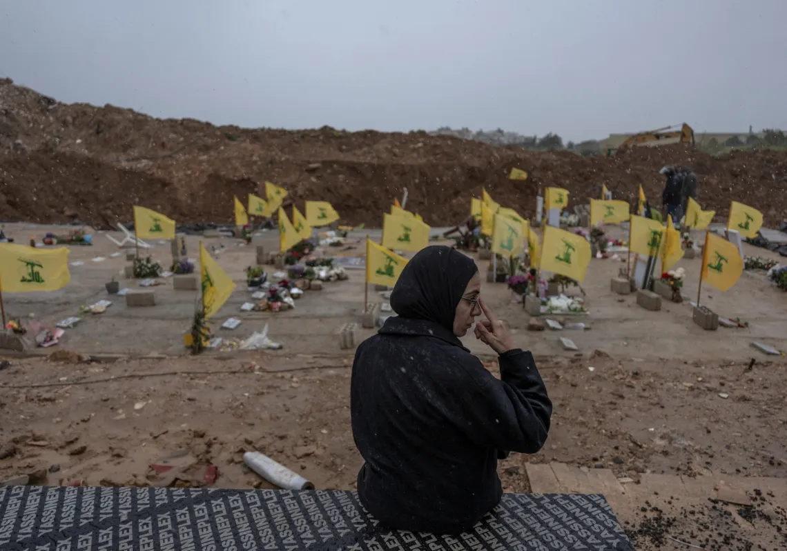 A woman mourns in a cemetery in Choueifat, Lebanon, on 29 March 2026, before the funeral of Lebanese journalists who were killed by a targeted Israeli strike.