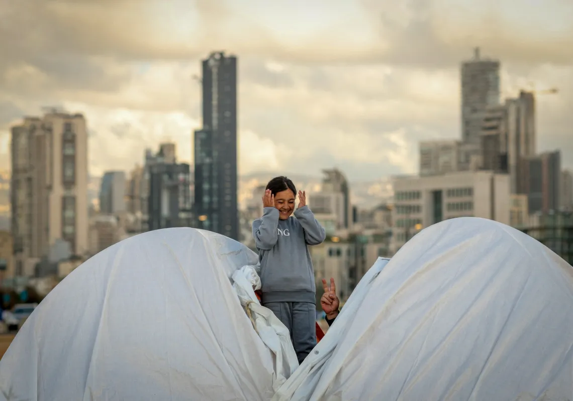 A girl holds her cat in a temporary encampment for displaced people in Beirut, on 30 March 2026, amid Israel's war on Lebanon.