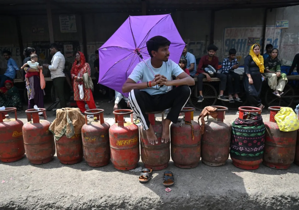 People wait to buy liquefied petroleum gas (LPG) cylinders at a gas agency office in Noida on 2 April 2026, amid ongoing oil and gas import disruptions caused by the Middle East war.