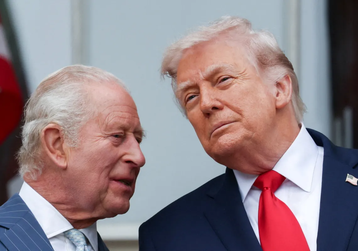US President Donald Trump and Britain's King Charles talk as they watch a pass in review during an arrival ceremony for the king and Queen Camilla, at the White House in Washington, DC, on 28 April 2026. 