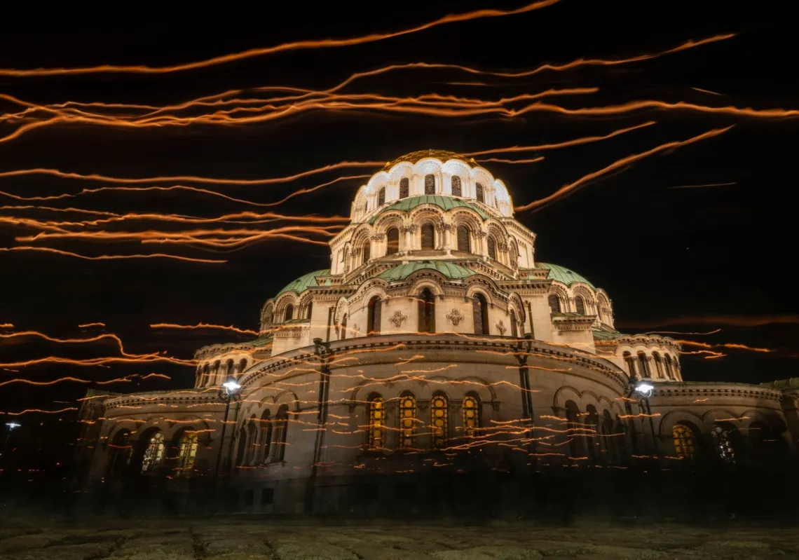 This long-exposure photograph shows the light from candles held by Bulgarian Orthodox worshippers during a midnight Easter mass in front of the Saint Alexander Nevsky Cathedral in Sofia, on 12 April 2026. 